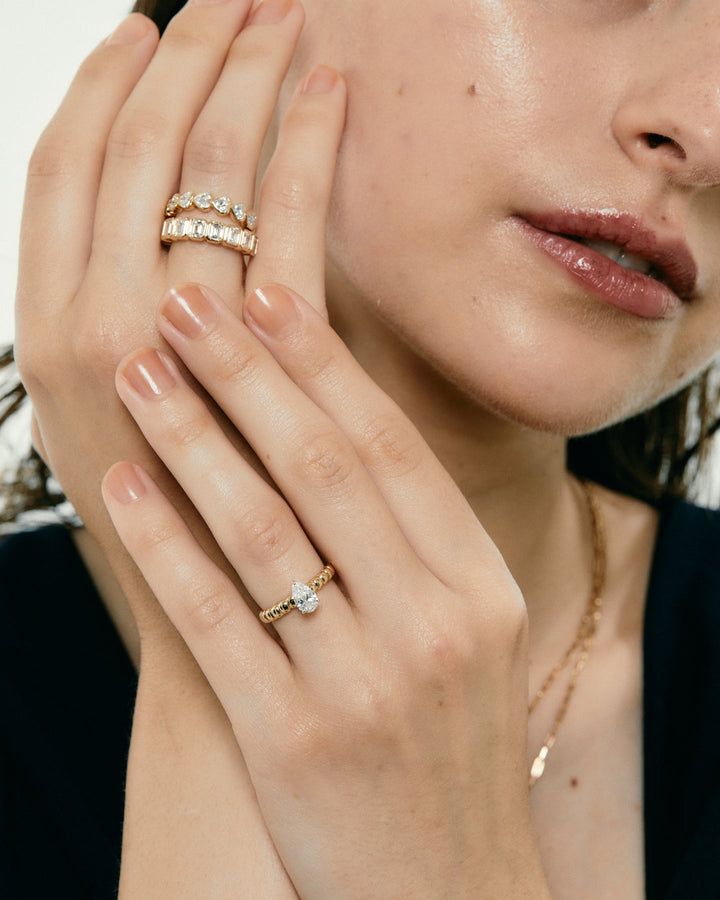 Detailed close-up of pear solitaire diamond engagement ring