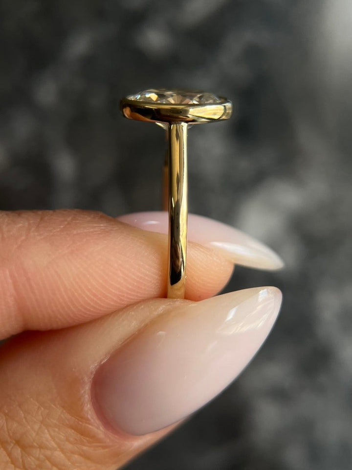 Top-down view of oval cut bezel engagement ring