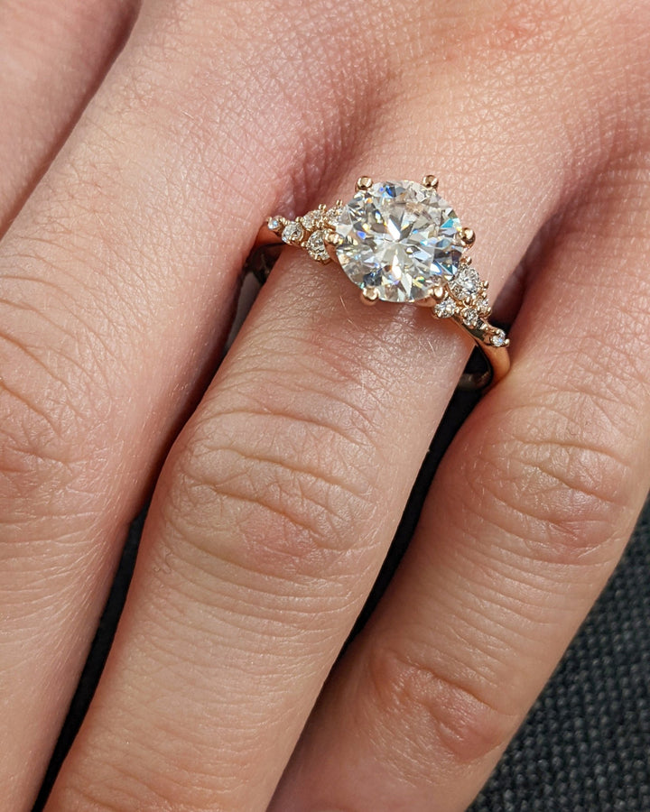 Round cut diamond ring worn on hand