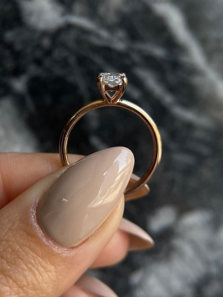 Radiant solitaire engagement ring photographed in natural light
