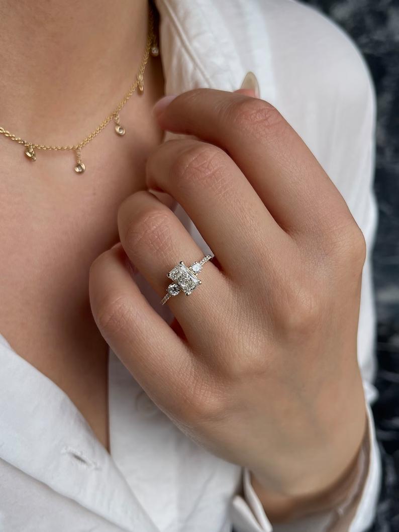 IGI certified radiant cut diamond in three stone engagement ring setting