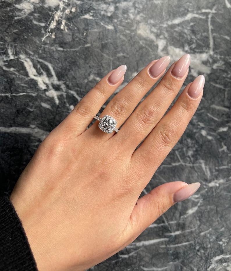 Round halo engagement ring offered in gold and platinum