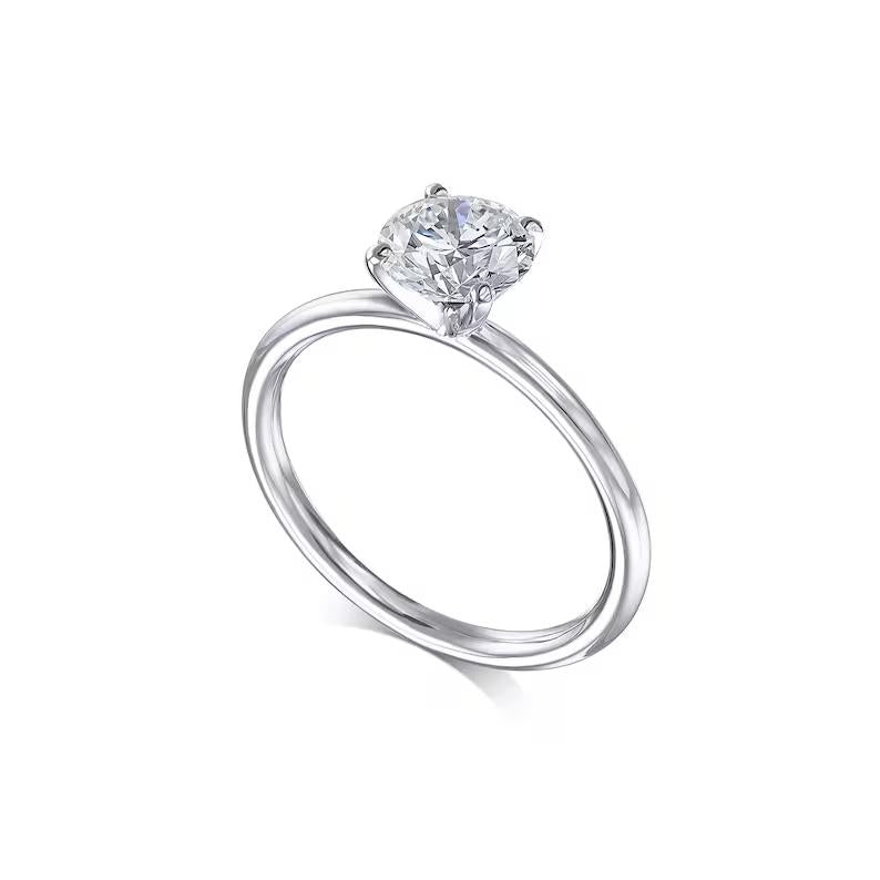 Round solitaire engagement ring photographed in natural light