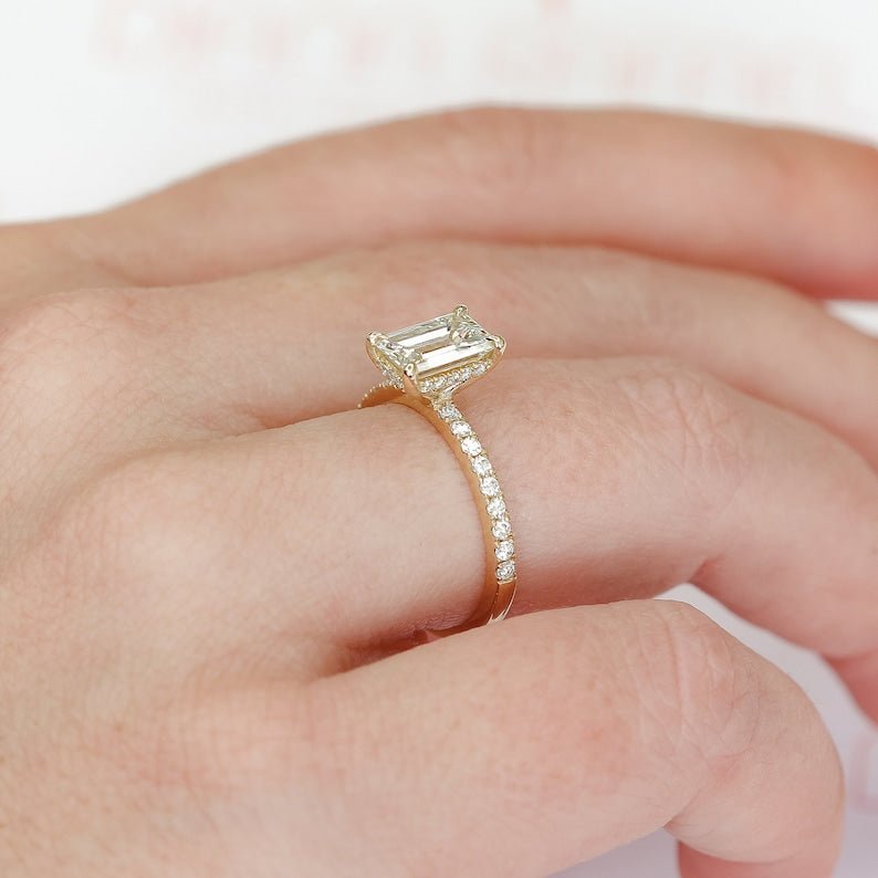 Emerald hidden halo engagement ring viewed from the side