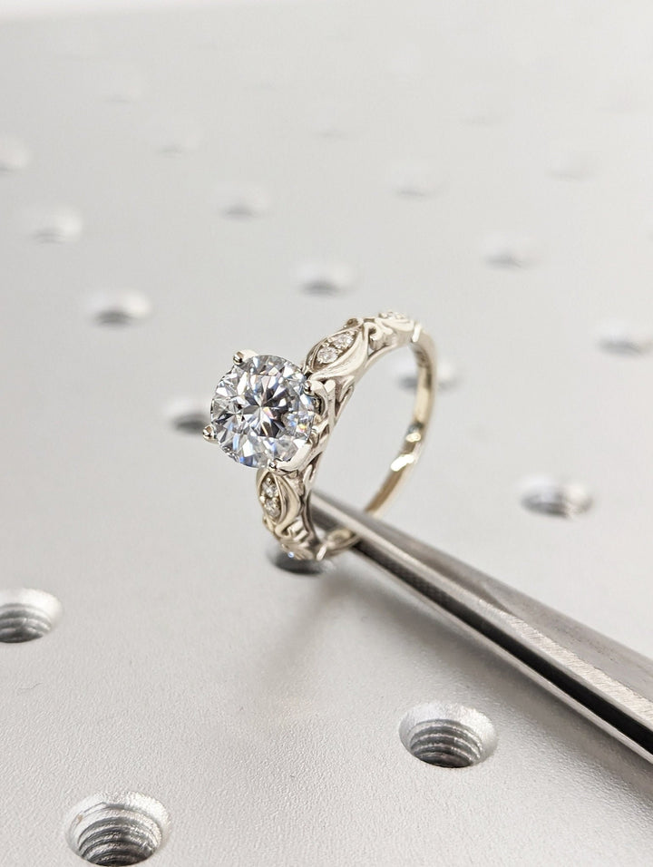 Round cut engagement ring side view showing band detail