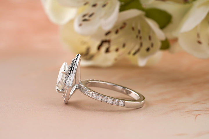 Detailed close-up of pear halo diamond engagement ring