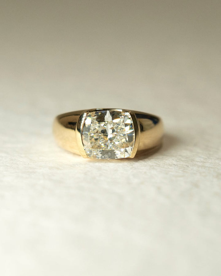Angled view of cushion cut diamond in bezel setting