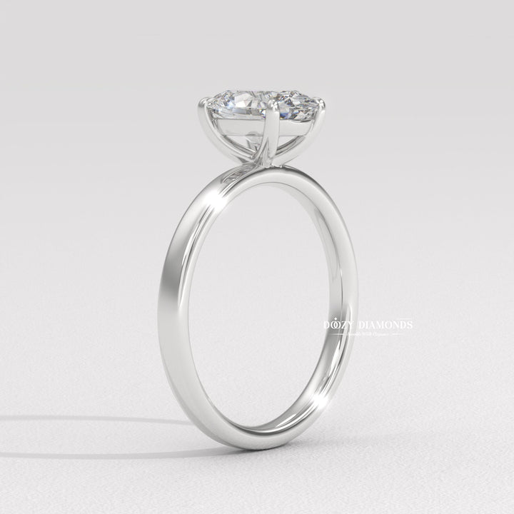 Oval solitaire engagement ring shown on hand for true-to-life sizing
