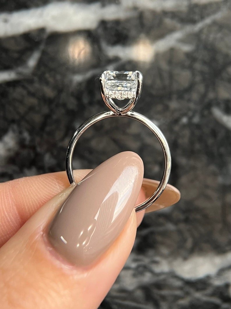 Emerald cut diamond ring worn on hand