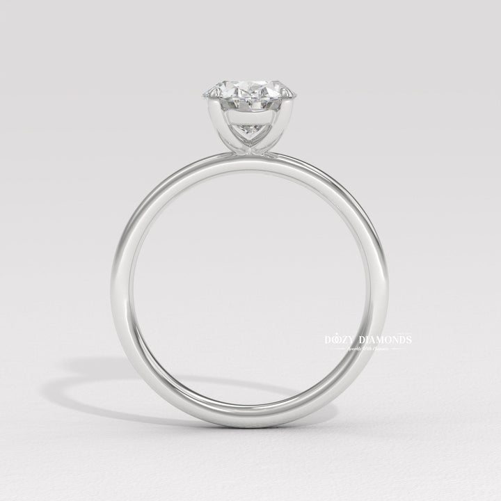 Oval cut diamond ring worn on hand