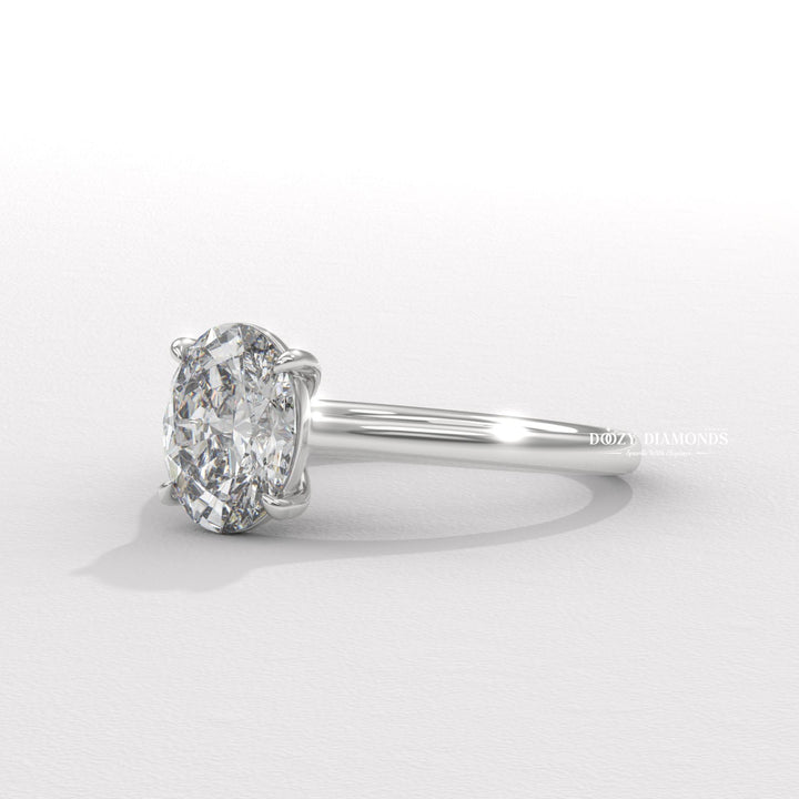 Lifestyle shot of oval solitaire diamond ring on hand