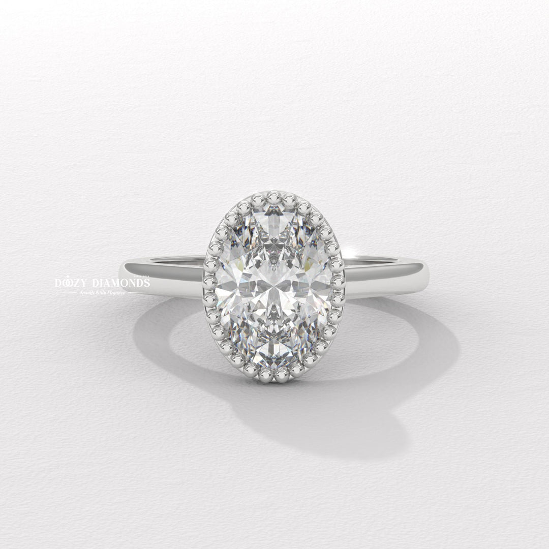 Close-up of oval cut center diamond in bezel engagement ring