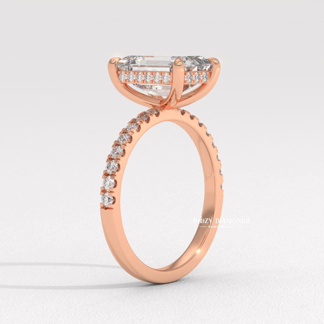 Emerald hidden halo engagement ring shown on hand for true-to-life sizing