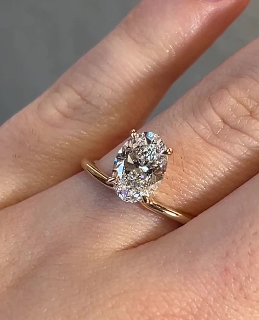 Detailed close-up of oval solitaire diamond engagement ring