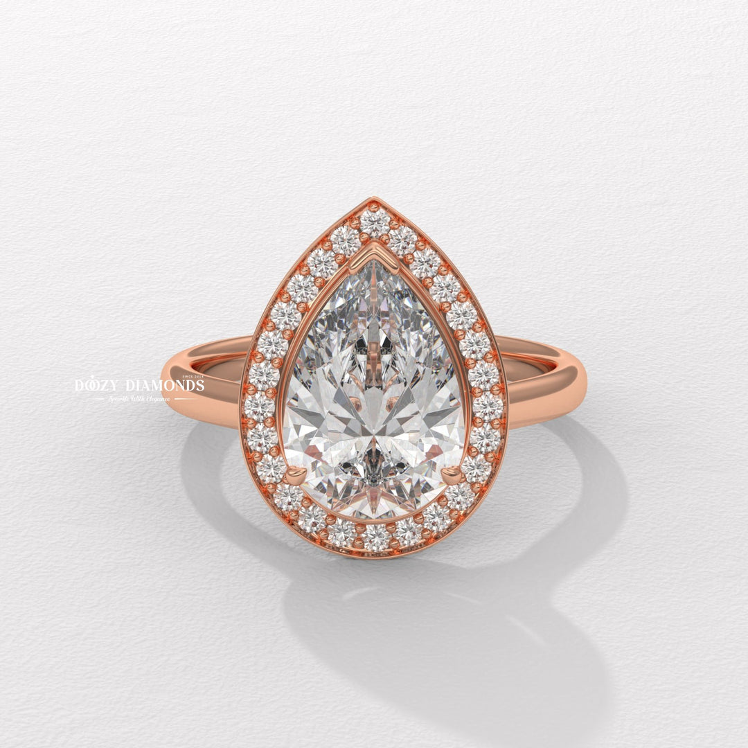 Unboxing view of pear cut halo diamond engagement ring