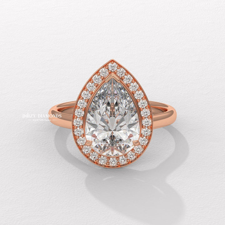 Unboxing view of pear cut halo diamond engagement ring