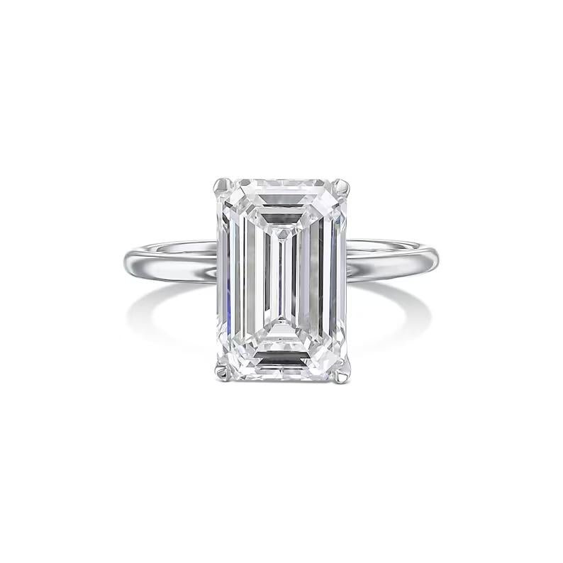 Unboxing view of emerald cut solitaire diamond engagement ring