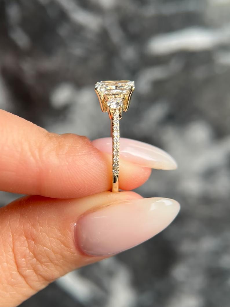 Certified radiant cut diamond featured in three stone engagement ring