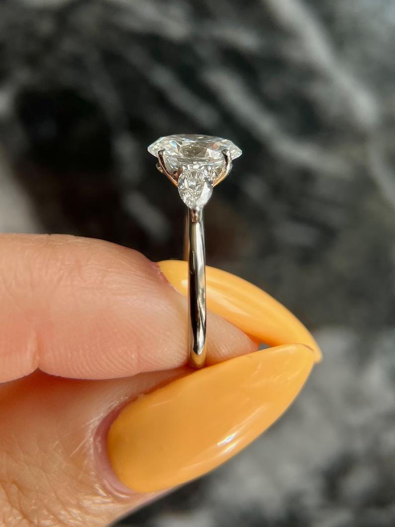 Oval three stone engagement ring viewed from the side