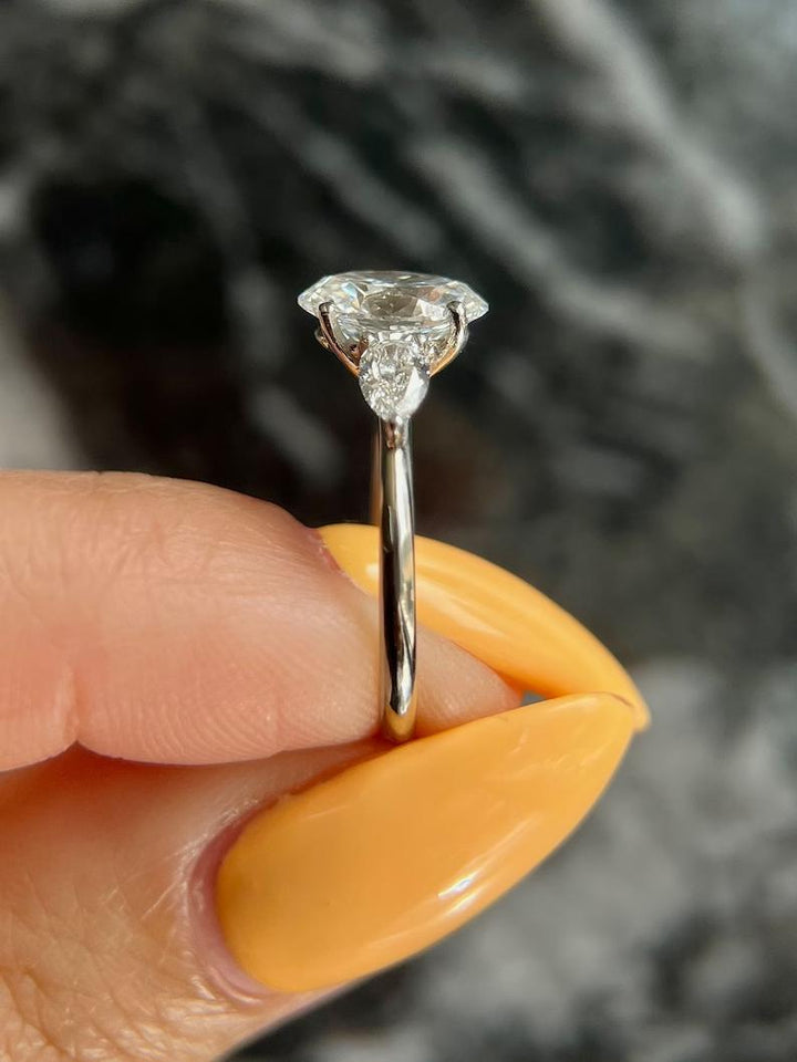 Oval three stone engagement ring viewed from the side