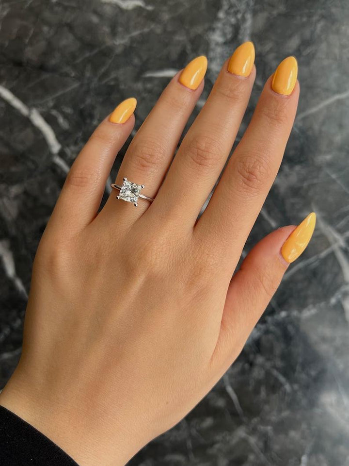 Princess solitaire engagement ring photographed in natural light