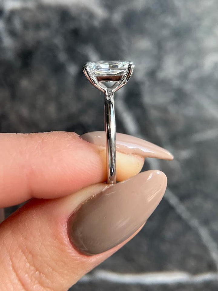 Radiant solitaire diamond ring displayed on jewelry stand