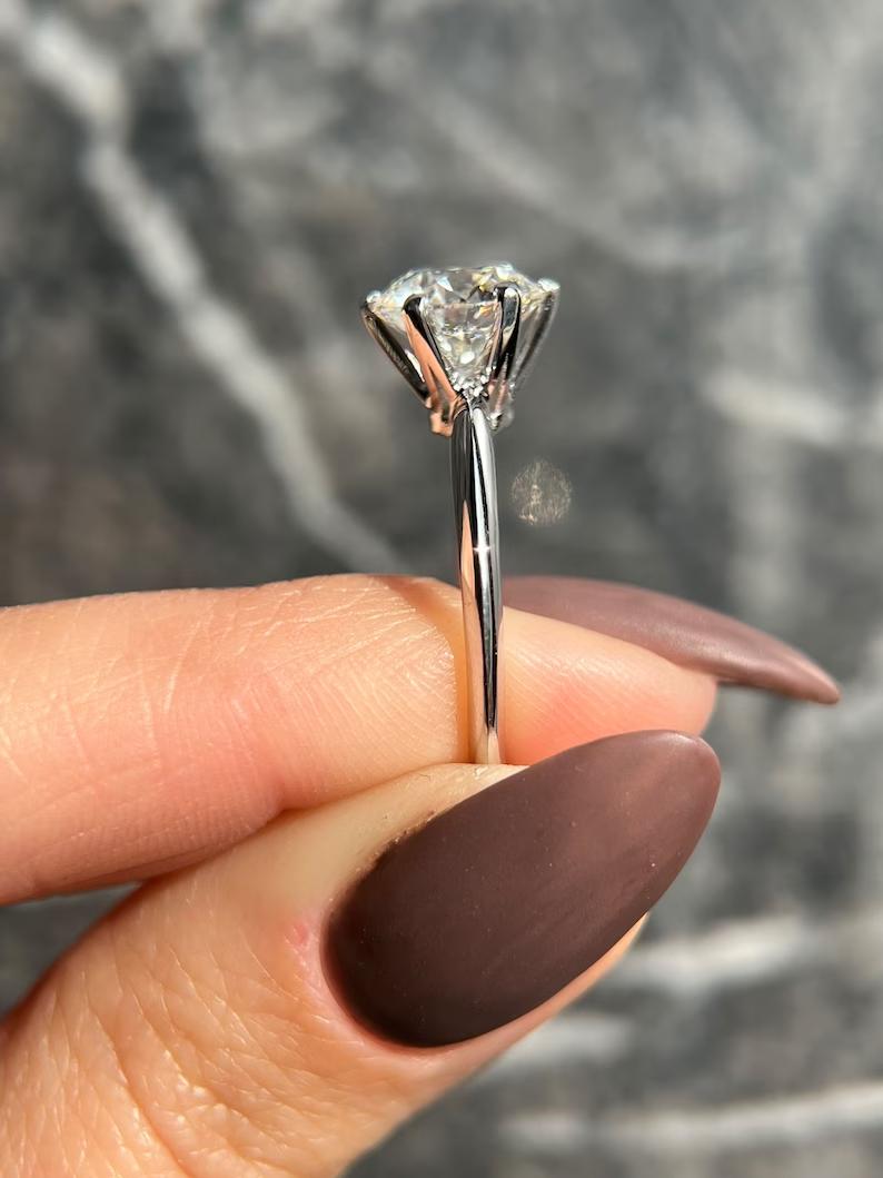 Unboxing view of round cut solitaire diamond engagement ring