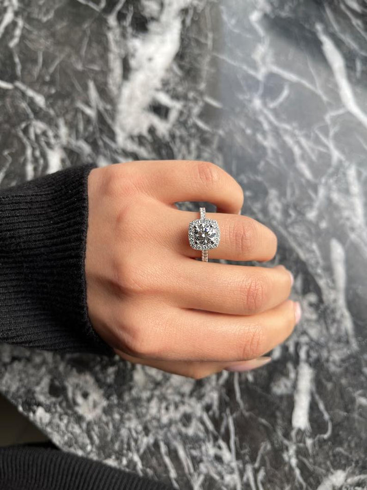 Round halo diamond ring presented in signature gift packaging