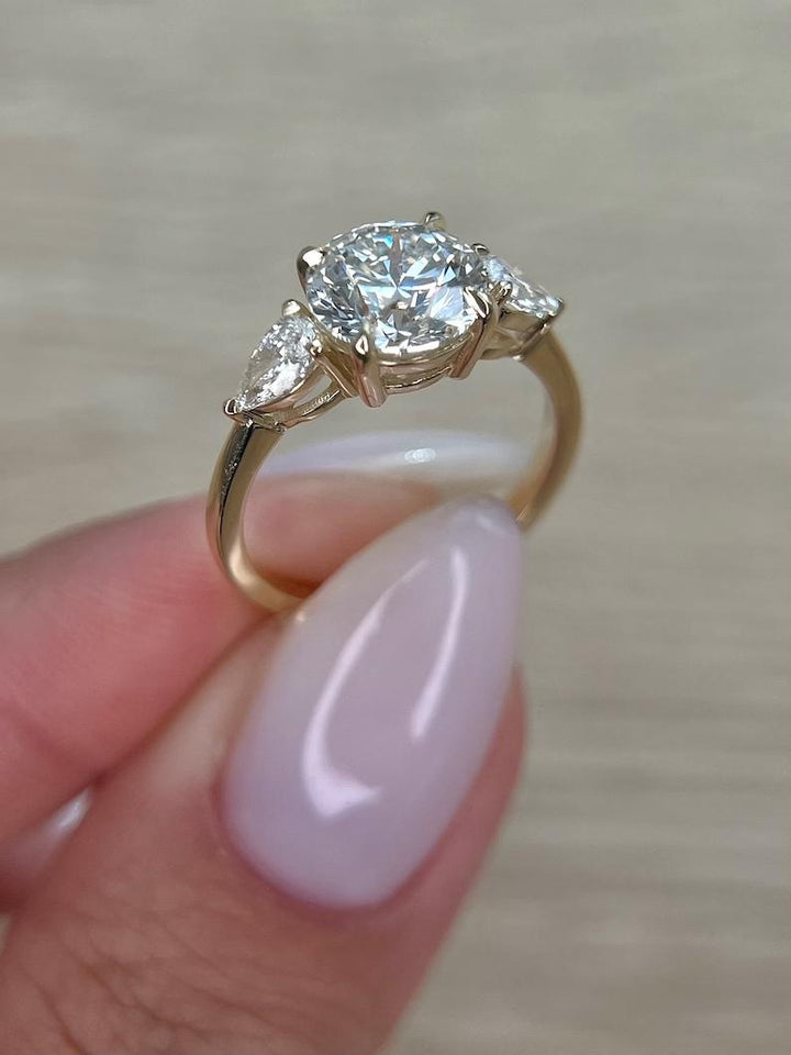 Round three stone lab grown diamond ring side profile in gold setting
