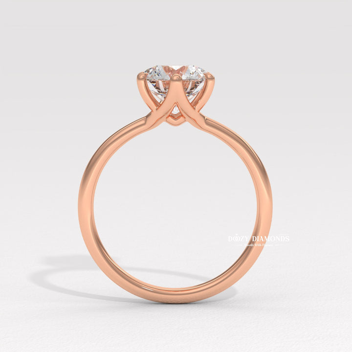 Round solitaire engagement ring photographed in natural light