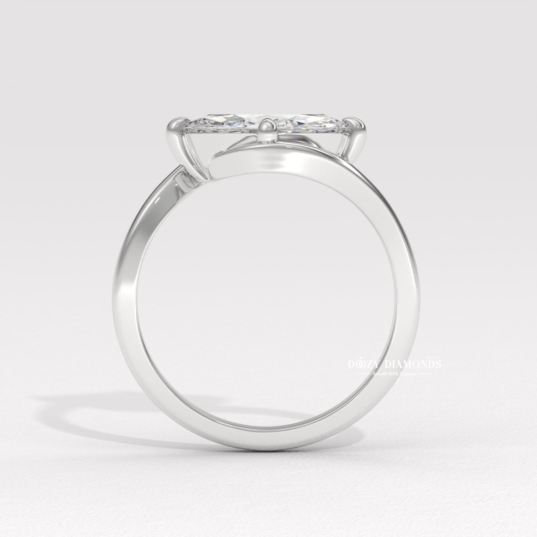 Close-up of marquise cut center diamond in east west engagement ring