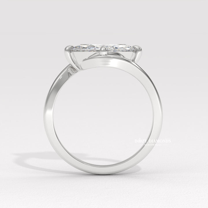 Close-up of marquise cut center diamond in east west engagement ring