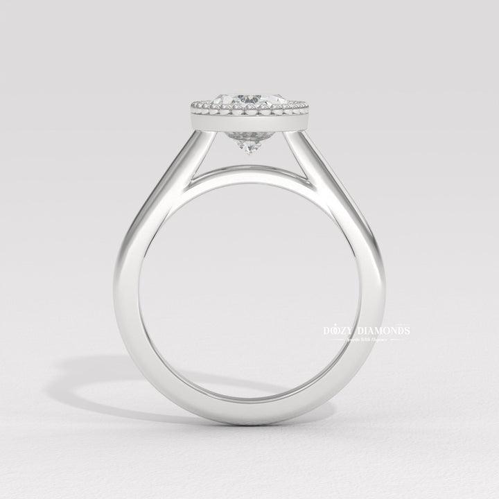 Detailed close-up of oval bezel diamond engagement ring