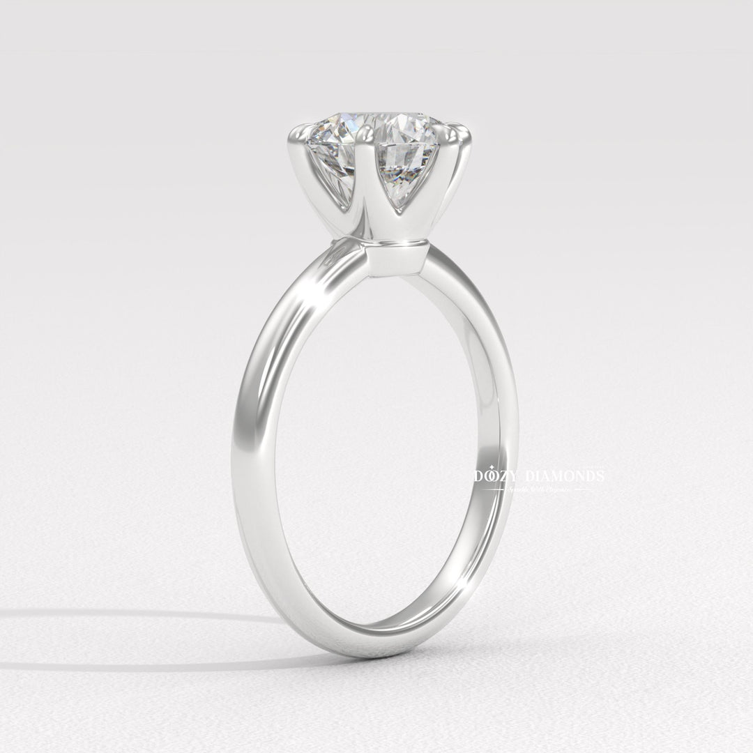 Round solitaire engagement ring shown on hand for true-to-life sizing