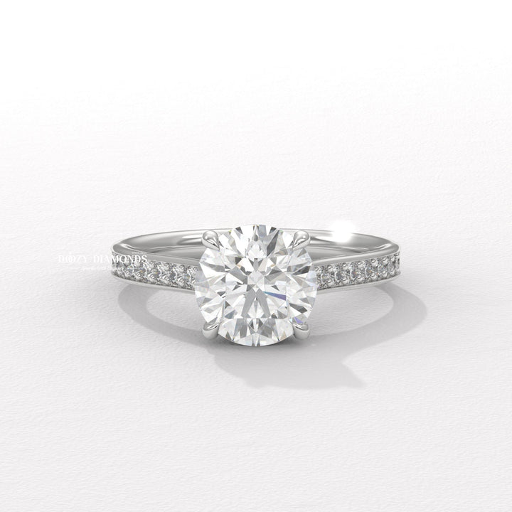 Round pave diamond ring displayed on jewelry stand
