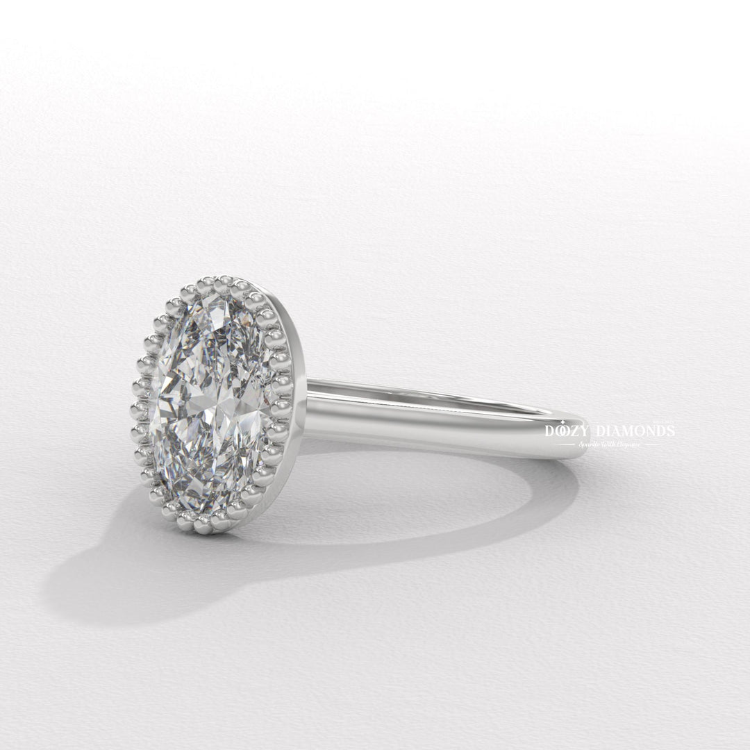 Oval bezel lab grown diamond ring side profile in gold setting