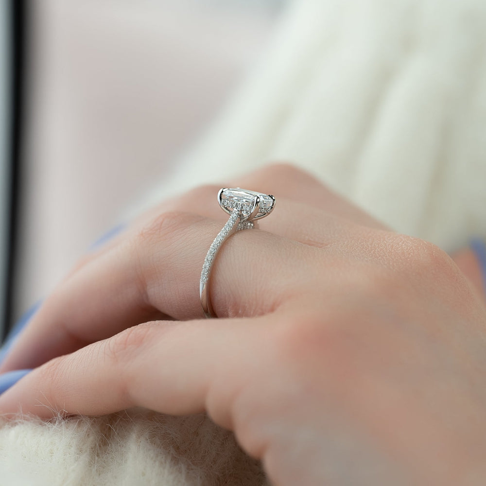 Radiant hidden halo engagement ring close-up showing E/VS1 diamond clarity