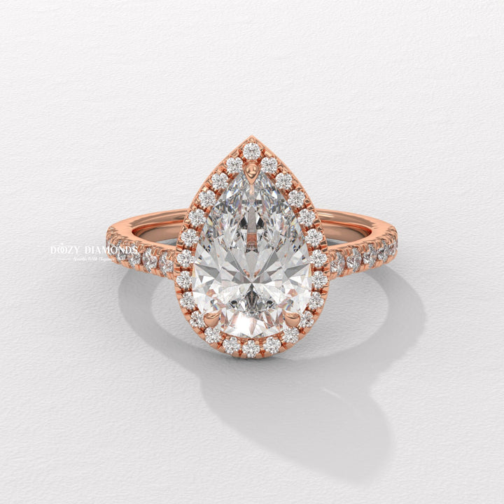 Close-up of pear cut center diamond in halo engagement ring