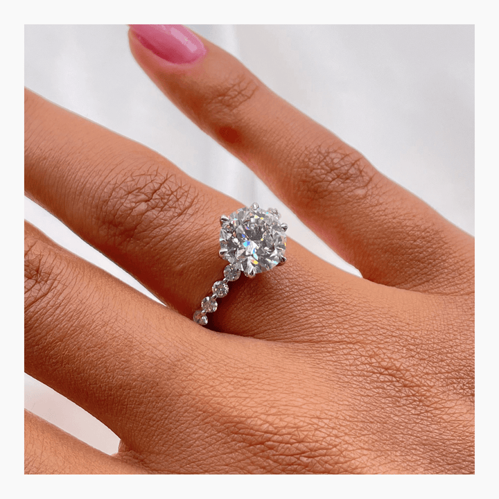 Unboxing view of round cut pave diamond engagement ring