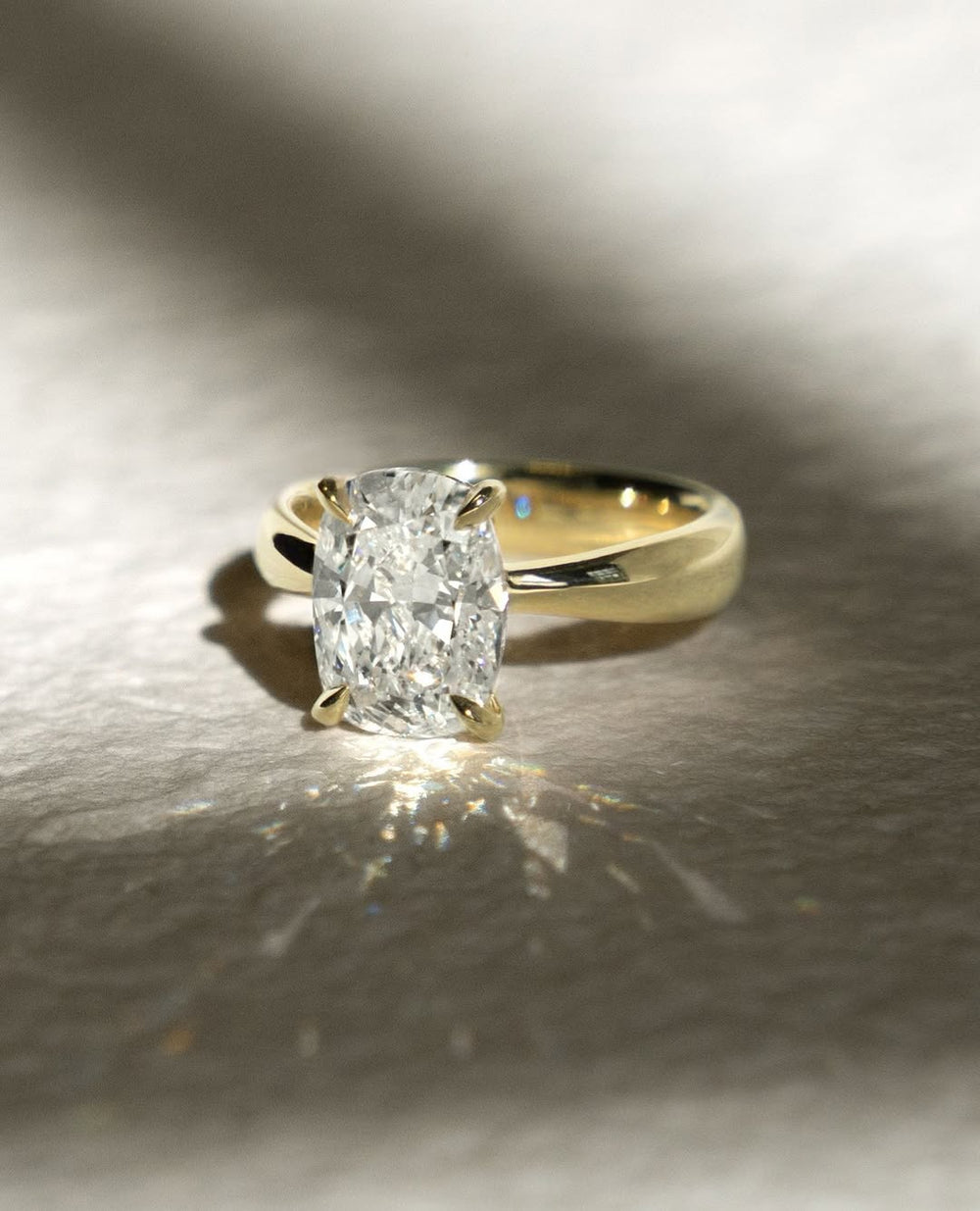 Detailed close-up of cushion split shank diamond engagement ring