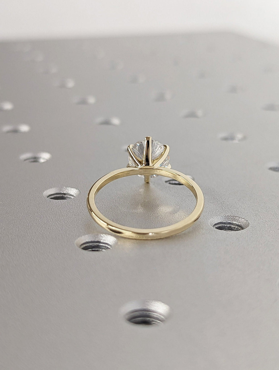 Round cut engagement ring shown with authenticity certificate