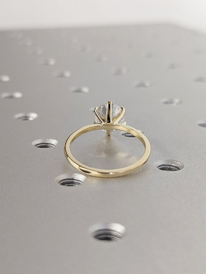 Round cut engagement ring shown with authenticity certificate