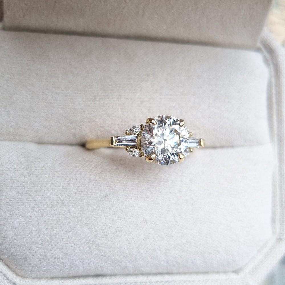 Round cluster engagement ring viewed from the side