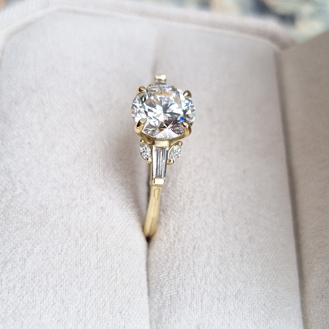 Round cluster engagement ring shown on hand for true-to-life sizing