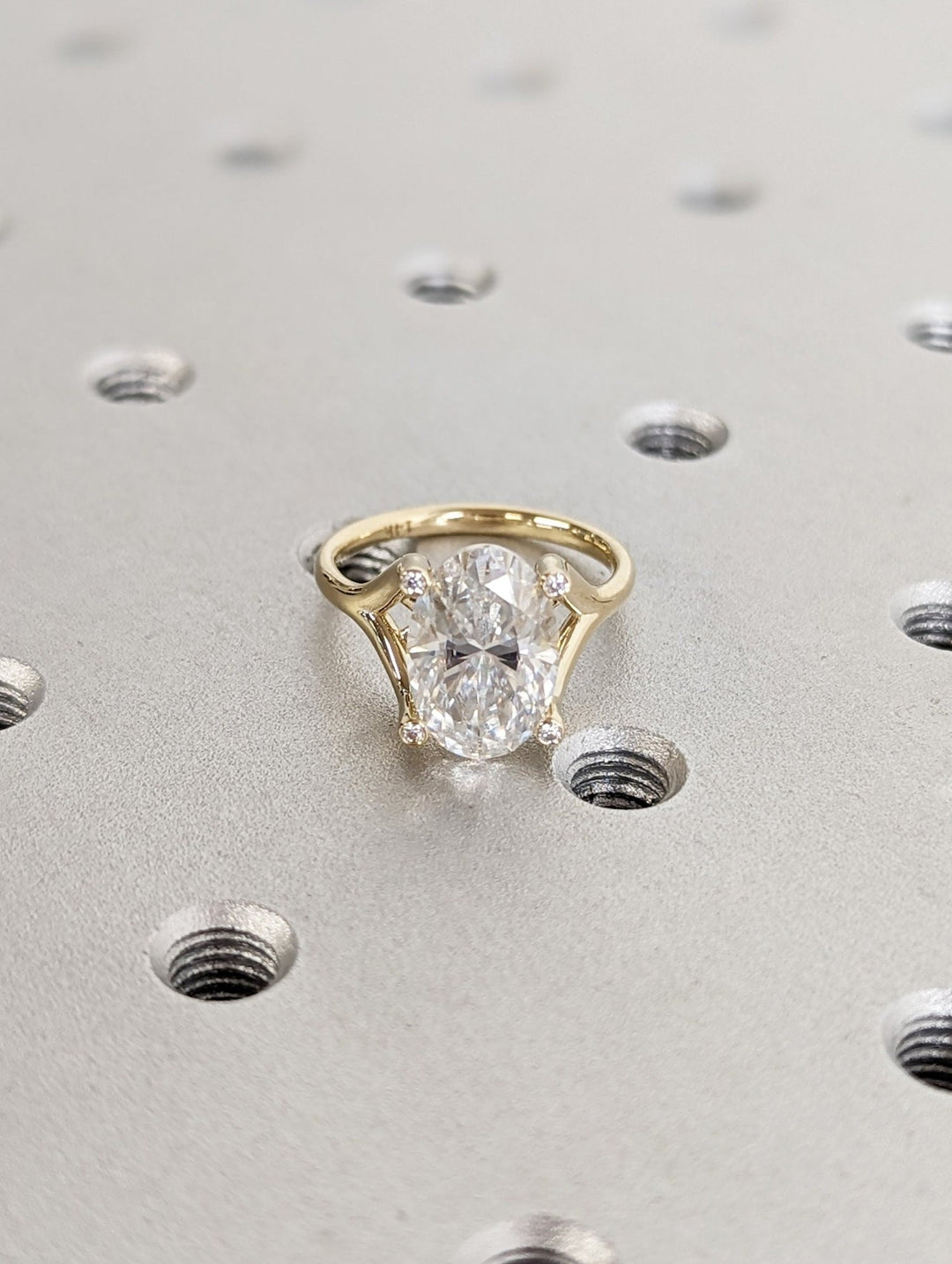 Oval cut engagement ring shown with authenticity certificate