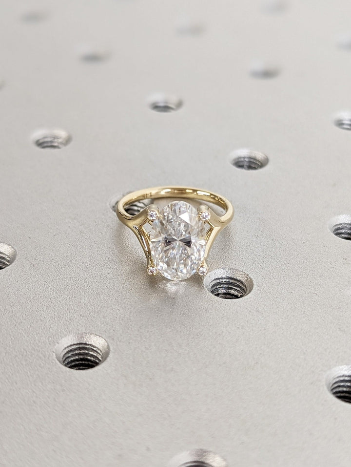 Oval cut engagement ring shown with authenticity certificate
