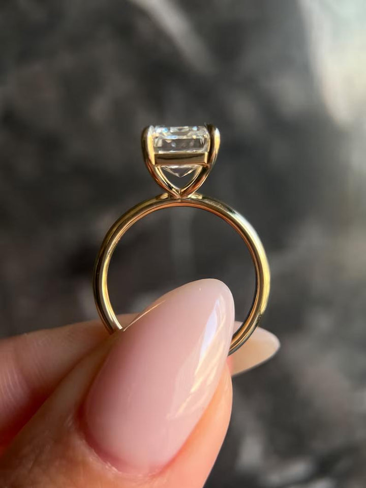 Macro shot of emerald cut diamond facets in solitaire ring setting