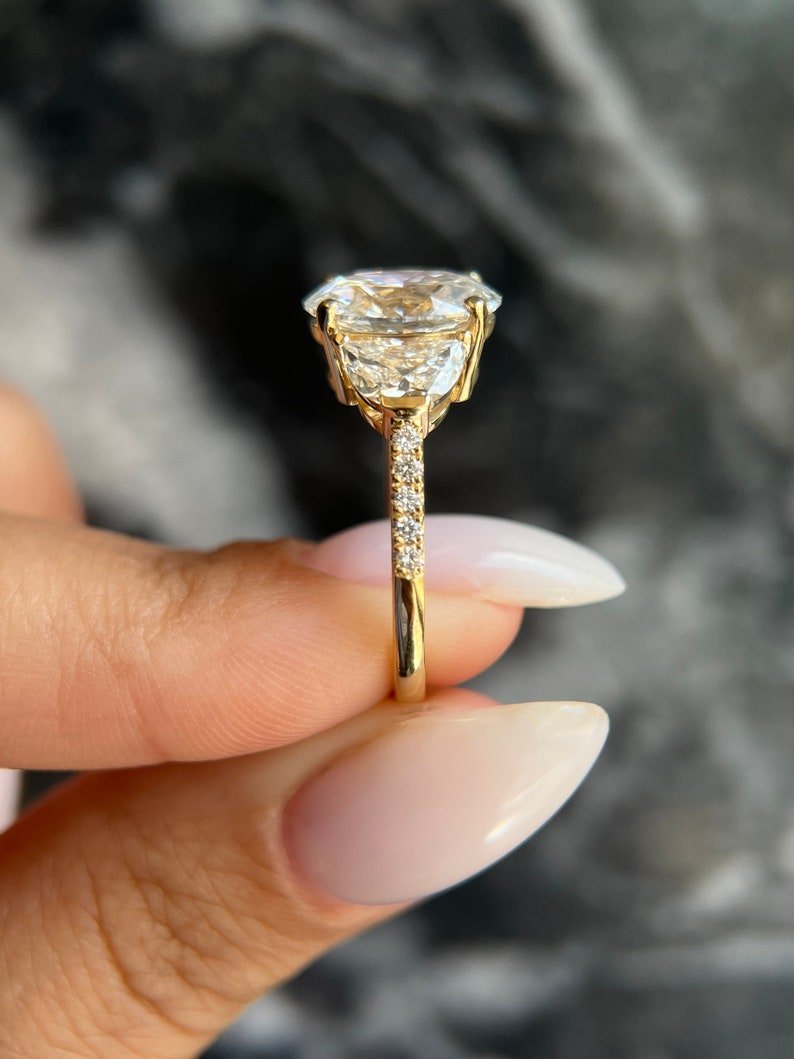 Oval three stone engagement ring viewed from the side