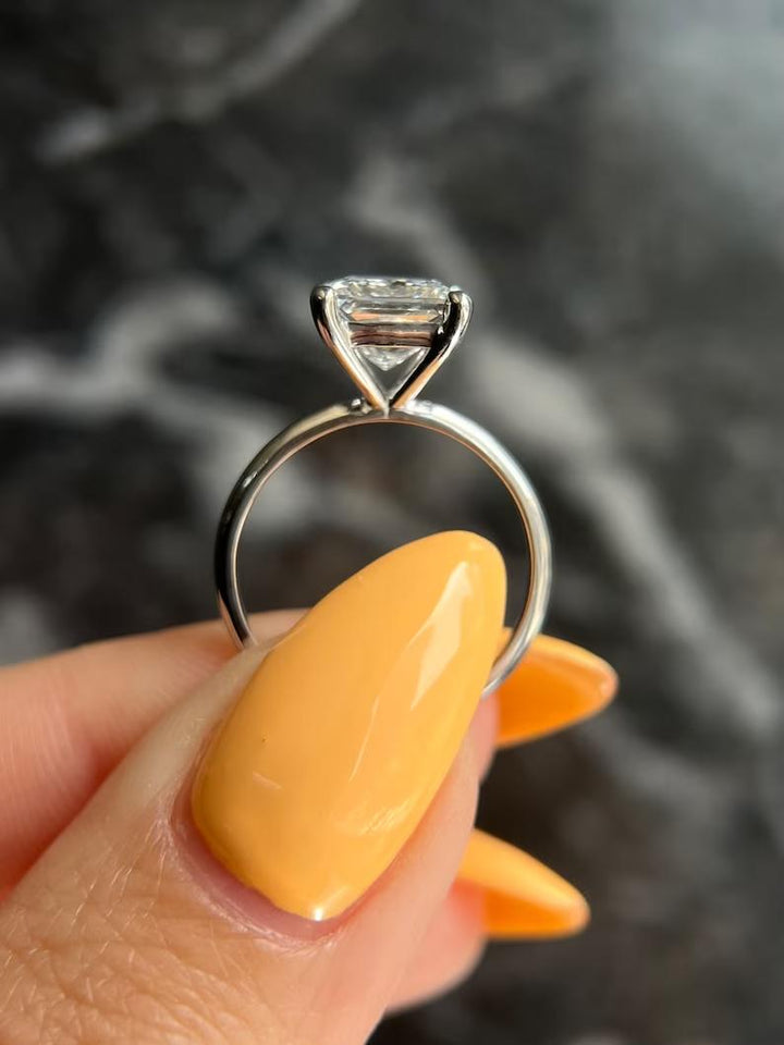 Close-up of princess cut center diamond in solitaire engagement ring