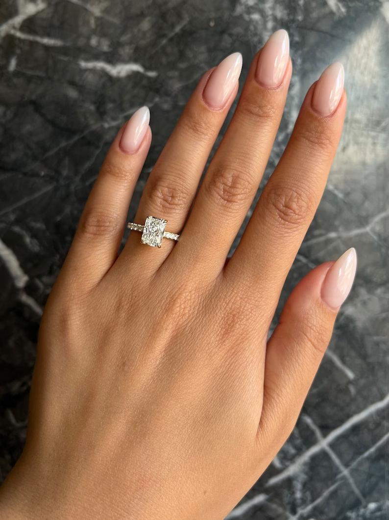 Radiant cut hidden halo engagement ring with IGI certified center diamond